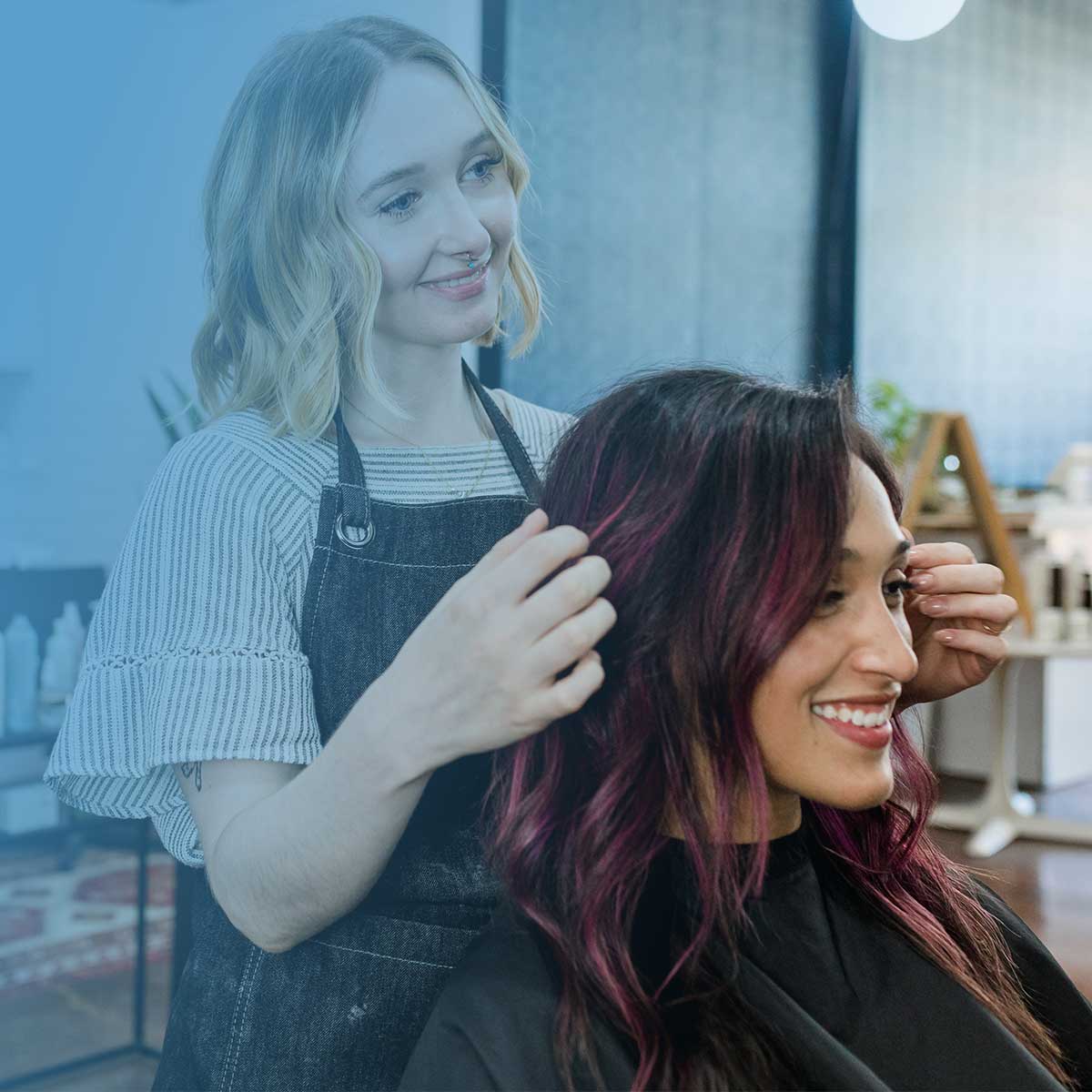 Hair stylist working with a client in a salon