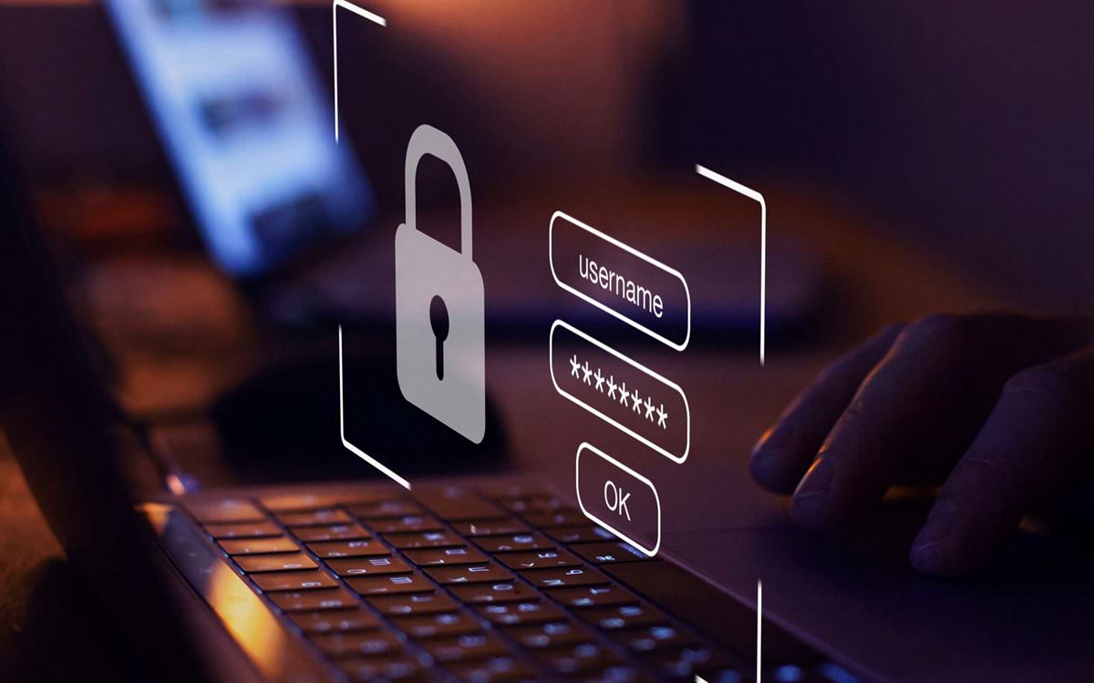 Person using a laptop with a padlock and login screen shown above the keyboard